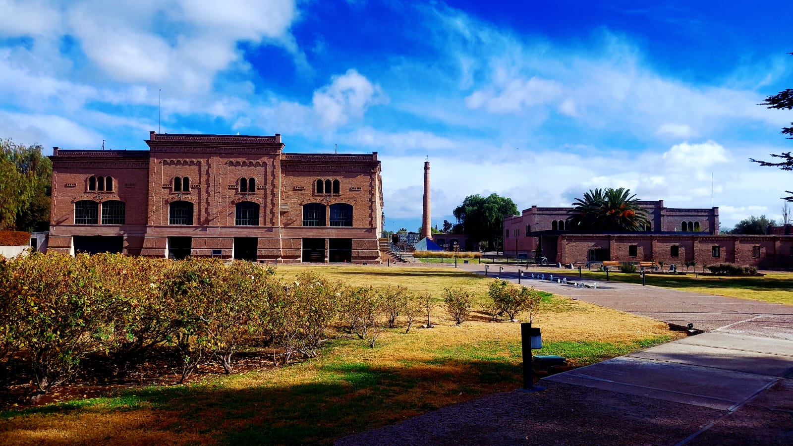 Entrada panorámica de la bodega Trapiche en Mendoza, rodeada de viñedos al atardecer